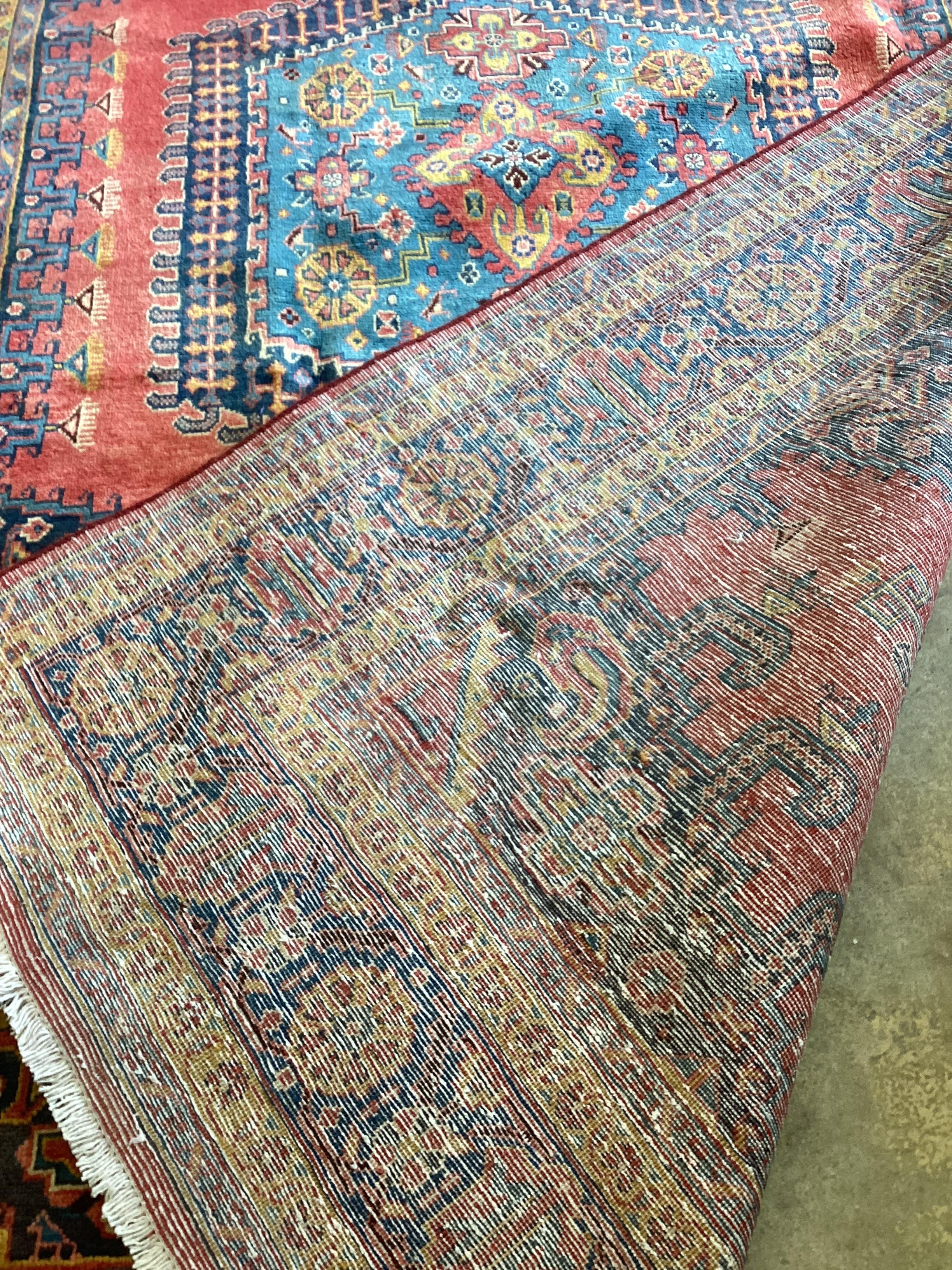 A Veis red ground carpet, 320 x 200cm